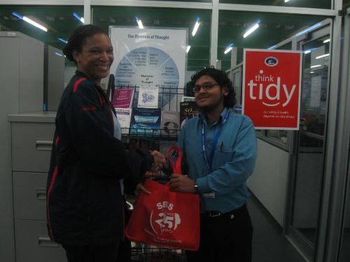 Kevin Rufus presents Mrs Alicia Williams-Julien with her SBCS token.